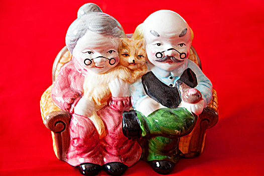 雕刻着一对老夫妇和猫的陶瓷娃娃