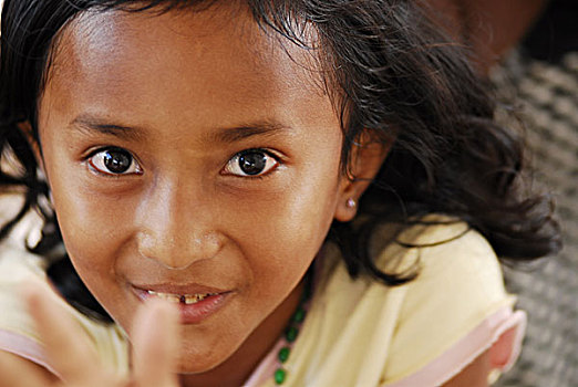 timorese,child,trying,to,reach,top,of,window