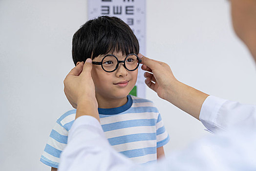 眼科大夫给小男孩检查眼睛