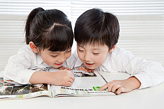 穿白襯衫坐在椅子上的小學生