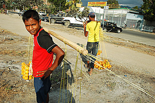 2,young,timorese,boys,hiding,behind,yellow,books