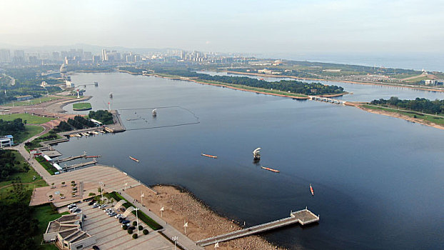 山东省日照市,碧波荡漾的奥林匹克水上公园,游客划龙舟体验水上乐趣