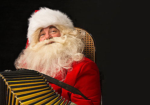圣诞老人,坐,扶手椅,在家,演奏音乐,手风琴,圣诞聚会,高兴,许多,留白