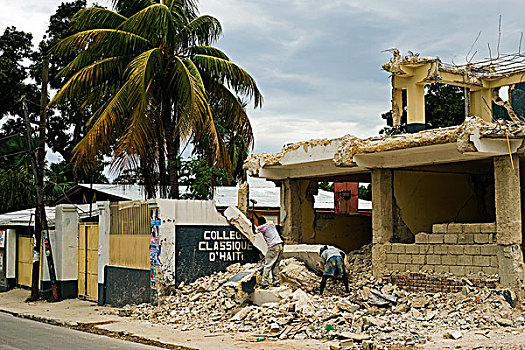 haiti,port,au,prince,man,working,reconstructing,destroyed,building