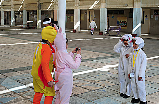 kuwait,city,kuwaiti,children,learning,to,take,photohgraphs,disguised,with,a,rabbit,costume