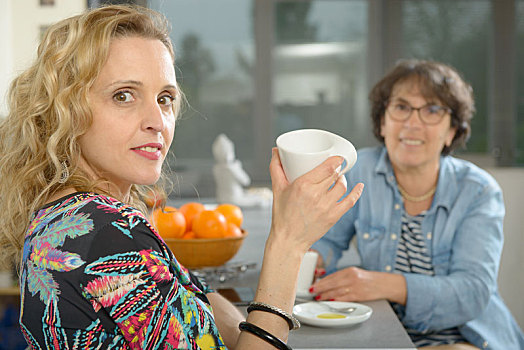 两个女人,坐,桌子,厨房,喝咖啡