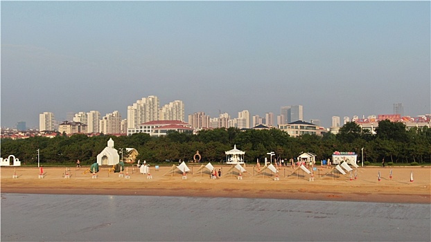 山东省日照市,雨后的海边环境宜人,游客赶海拾贝拍照打卡