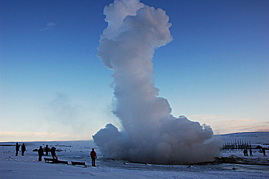 iceland,geysir,tourist,people,looking,at,steam,coming,out,from,the,geyser,in,snow,environment