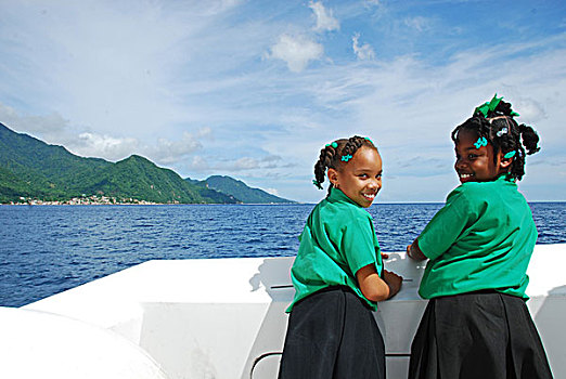 dominica,roseau,2,schoolgirls,looking,for,dolphines,and,whales,on,the,boat,trip,with,unicef,-,environmental,network,whalewatching