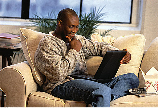 男人,坐,沙发,使用笔记本,电脑