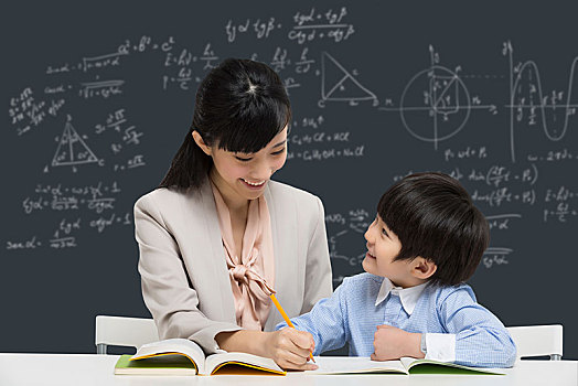 女教師輔導(dǎo)小男生學(xué)習(xí)