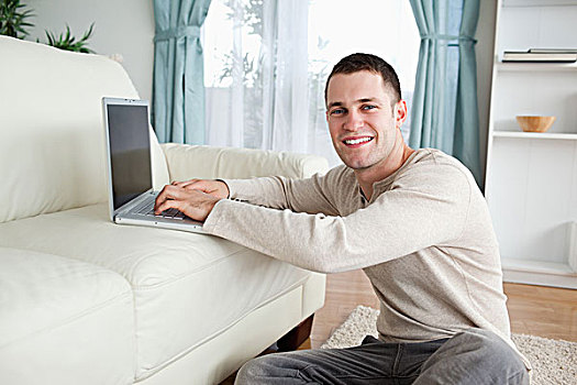微笑,男人,坐,地毯,笔记本电脑