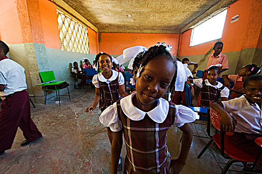 haiti,port,au,prince,portrait,of,girl,in,middle,classroom