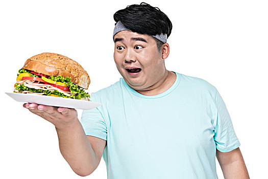 肥胖的年轻男子拿着汉堡