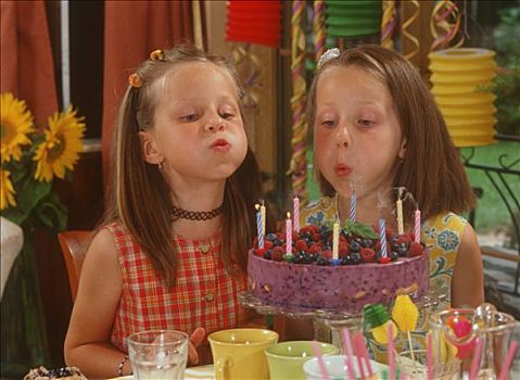 两个女孩,吹蜡烛,生日蛋糕