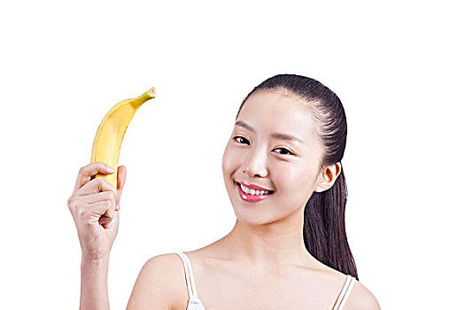 休闲女士手捧一根香蕉