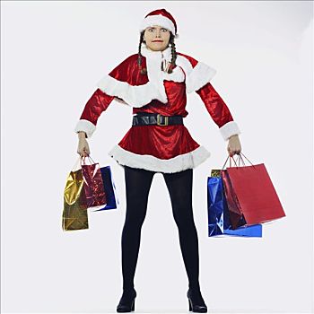 女人,装扮,圣诞老人,姿势,看,下雪,购物袋