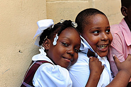 haiti,port,au,prince,schoolgirl,hugging,schoolboy