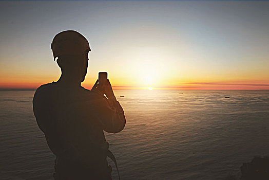 剪影,攀岩者,拍照手机,摄影,平和,日落,上方,海洋