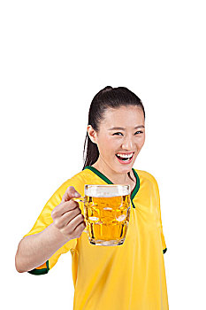 一个穿足球队服喝啤酒的女青年