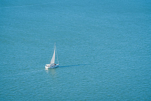 航拍蔚蓝色海面上的一艘帆船