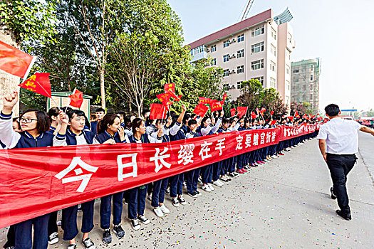 豫北某高中高二学生为高三高考考生摇旗呐喊夹道欢送进考场