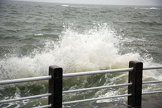 山东省日照市,灯塔风景区风大浪高,游客冒雨观赏浊浪排空奇观