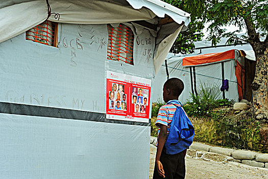 haiti,port,au,prince,petionville,club,camp,boy,looking,at,missing,children,advertisement