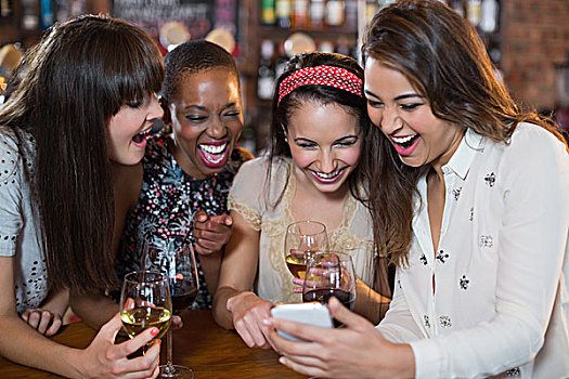 高兴,女性朋友,葡萄酒杯,打手机,酒吧