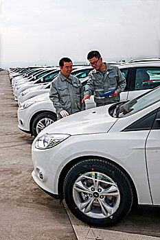 重庆长安民生物流股份有限公司员工正在对储运前的车辆进行外观检查