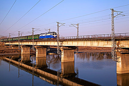 客运火车驶过老旧的铁路桥