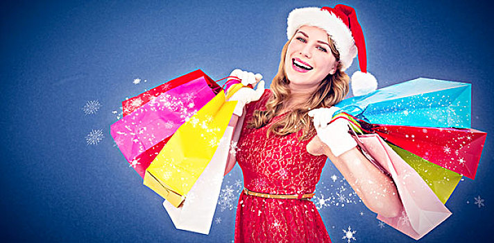 合成效果,图像,兴奋,金发,圣诞帽,拿着,购物袋,蓝色背景