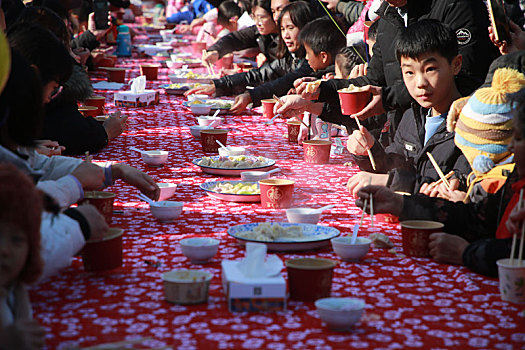 小镇摆下百米长桌宴,市民游客新年吃饺子交好运