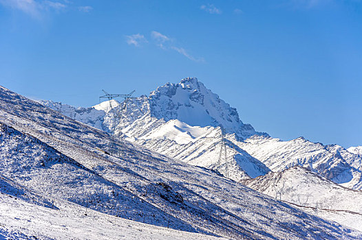新疆高海拔雪山上的高压线塔